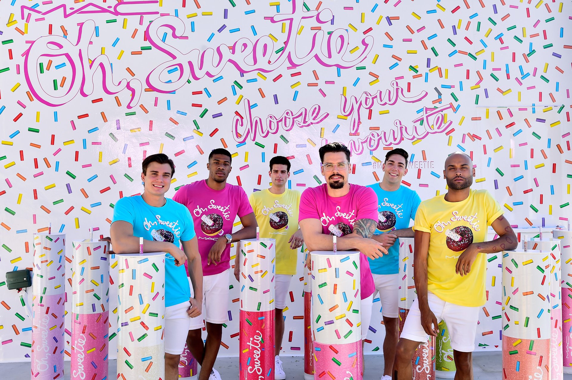 Six men posing at an event for MAC. Staffed Inc recruits from the LGBTQ community, creating job opportunities where there once weren't many. 