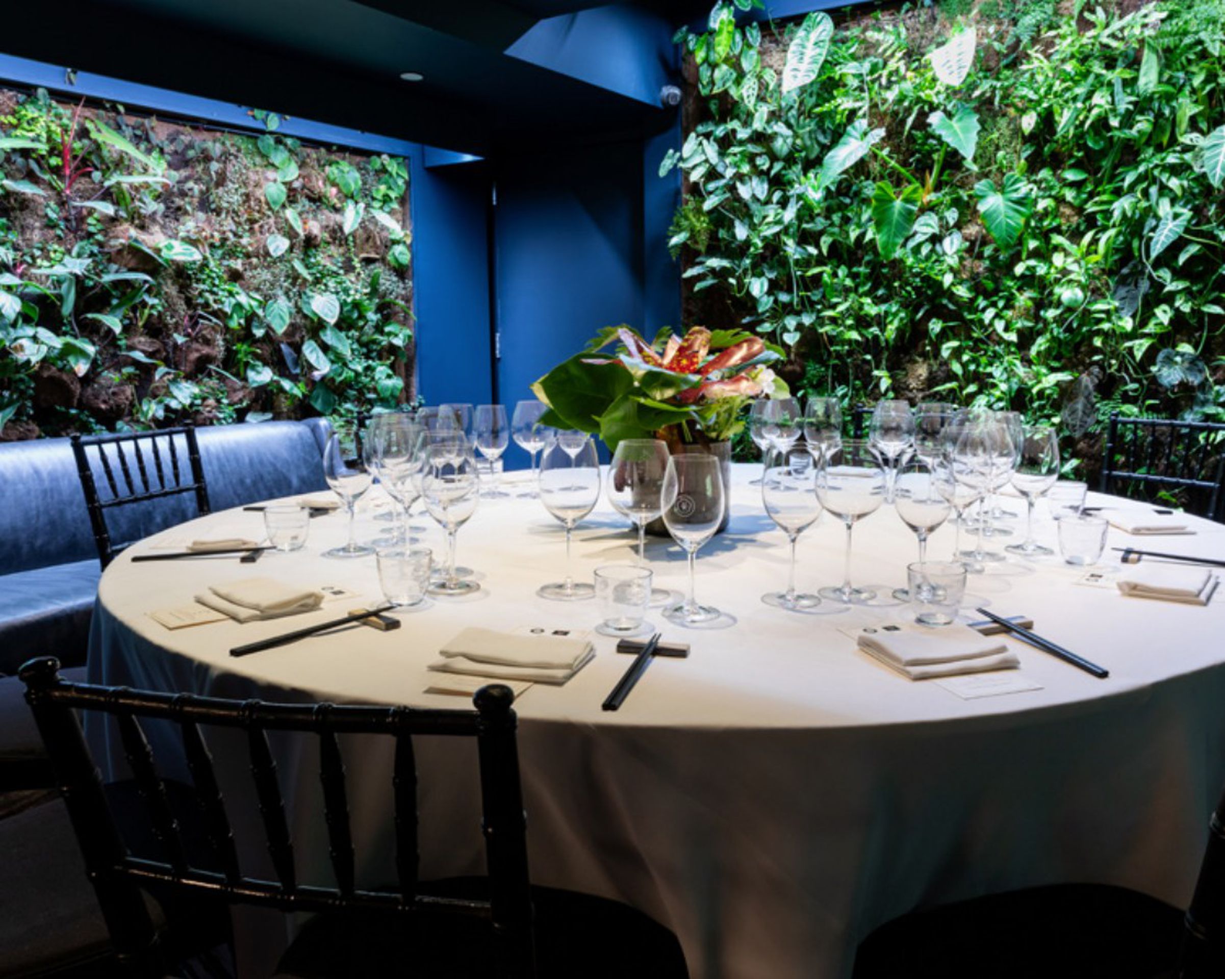 Round table next to greenery wall