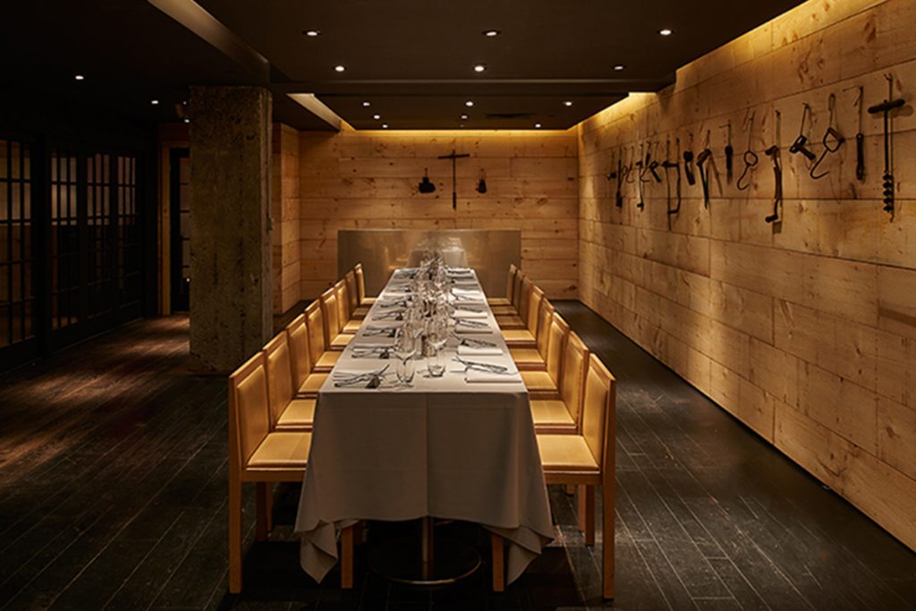 Long dining table in wooded room