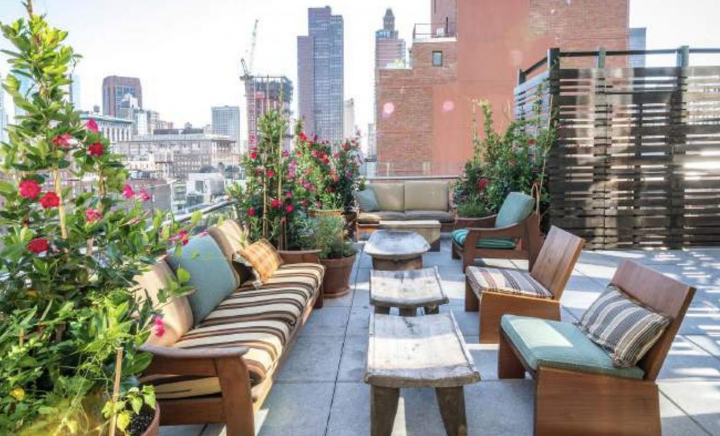 A rooftop in New York city with seating areas