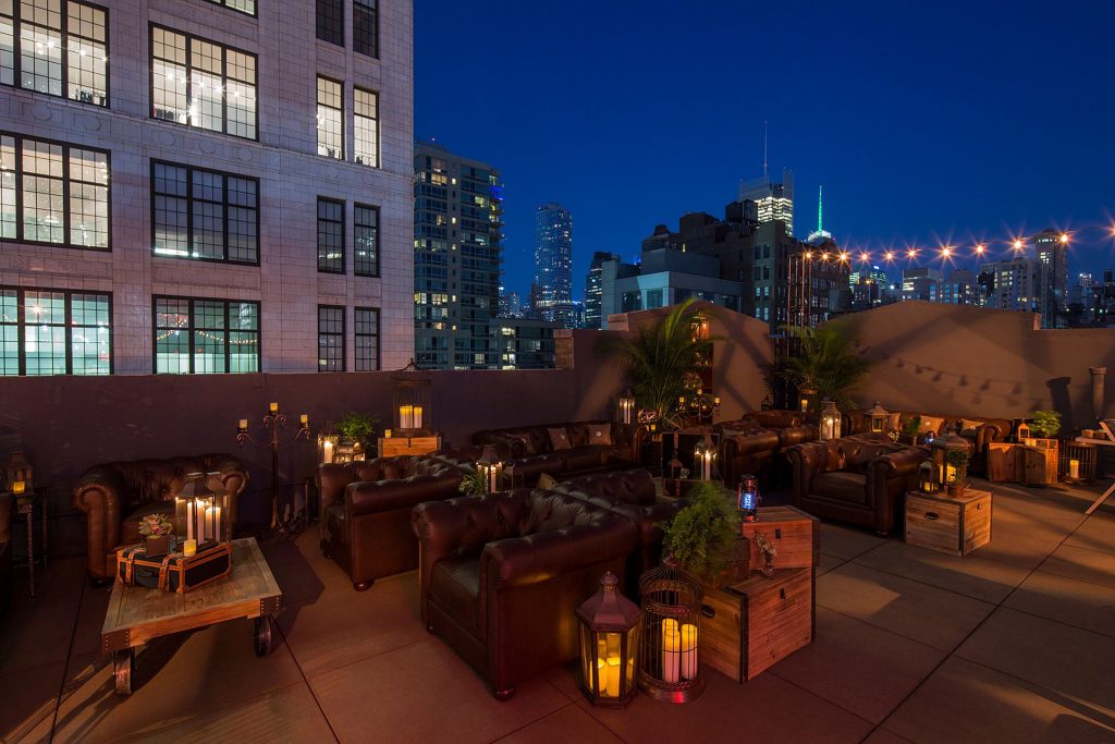 Dark rooftop bar with glowing floor lanterns