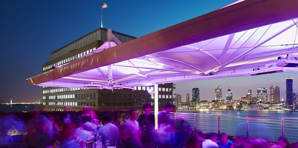 Rooftop venue with awning at night