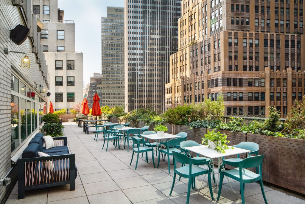 Rooftop deck with teal blue table and chair settings