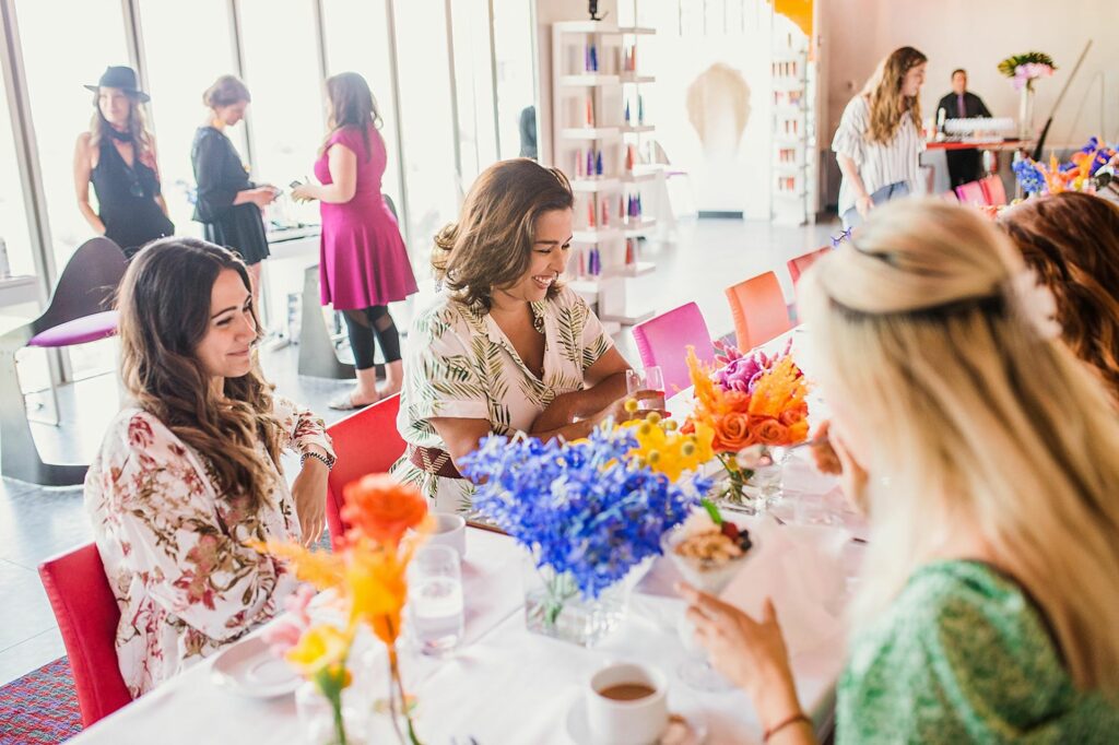 Women sitting at a table with colorful flowers