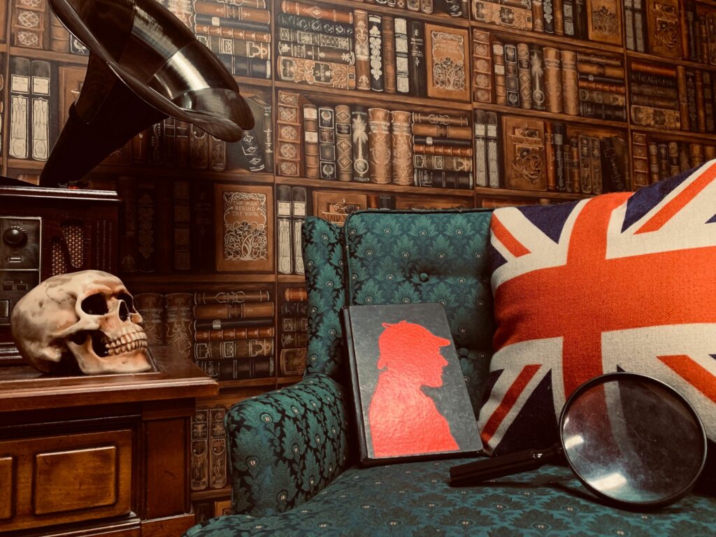 A green chair and a library next to a surface with a fake skull on it