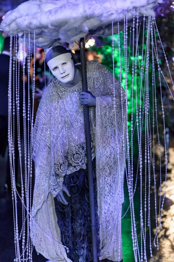 Person in a mask holding an umbrella