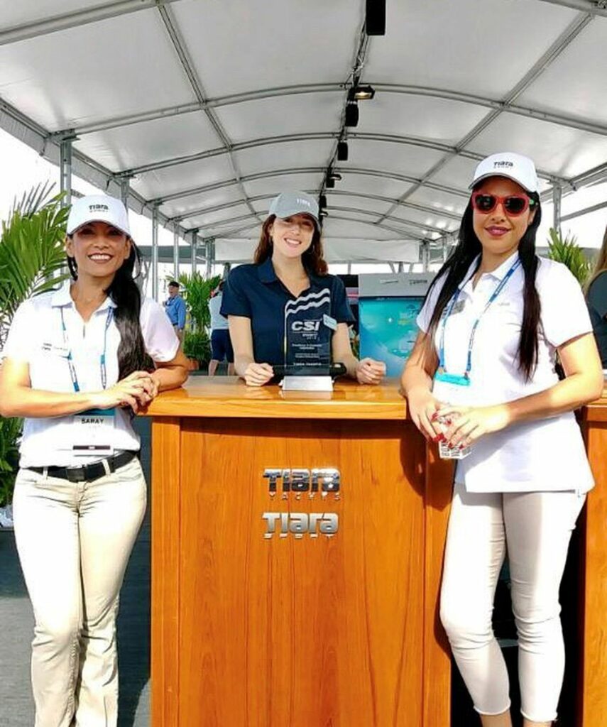 Women in baseball hats standing at a podium