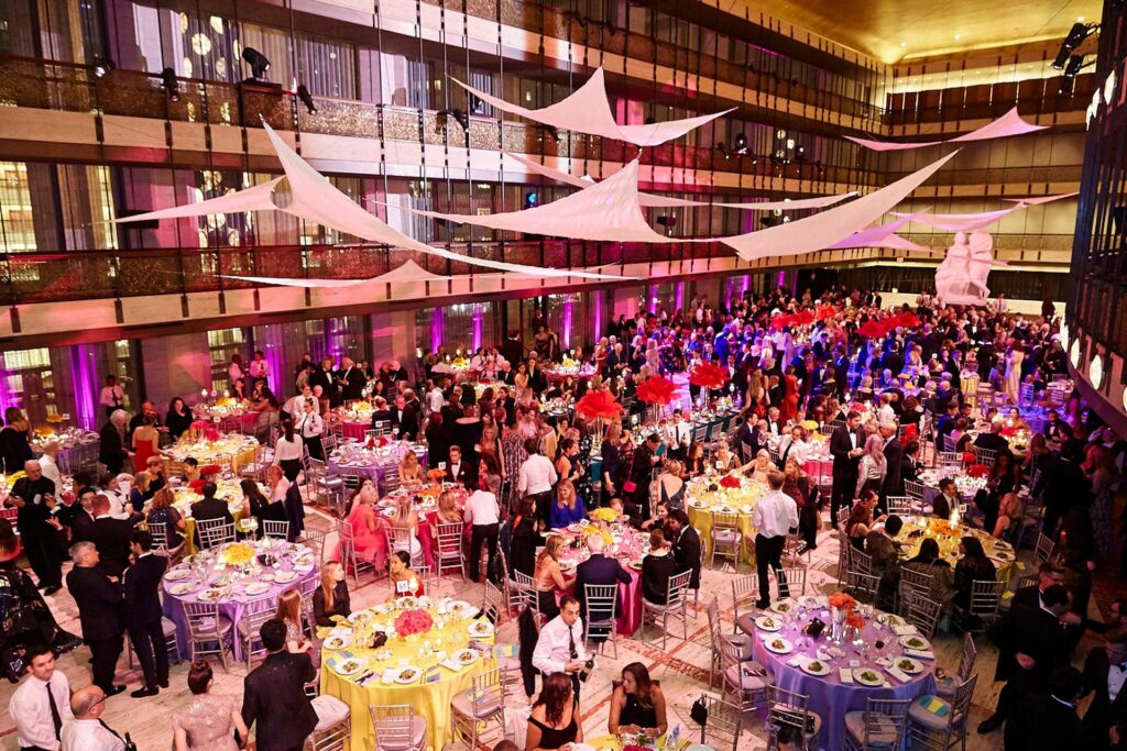 Aerial view of a large event with several tables and hundreds of people