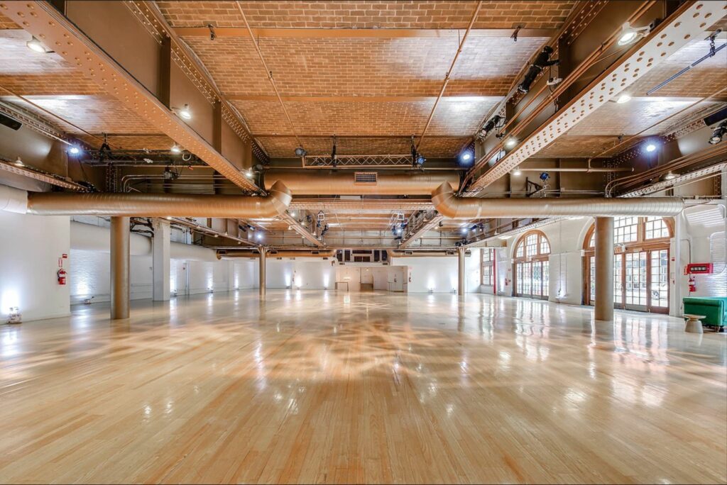 A large blank raw space with natural light and brick ceiling 