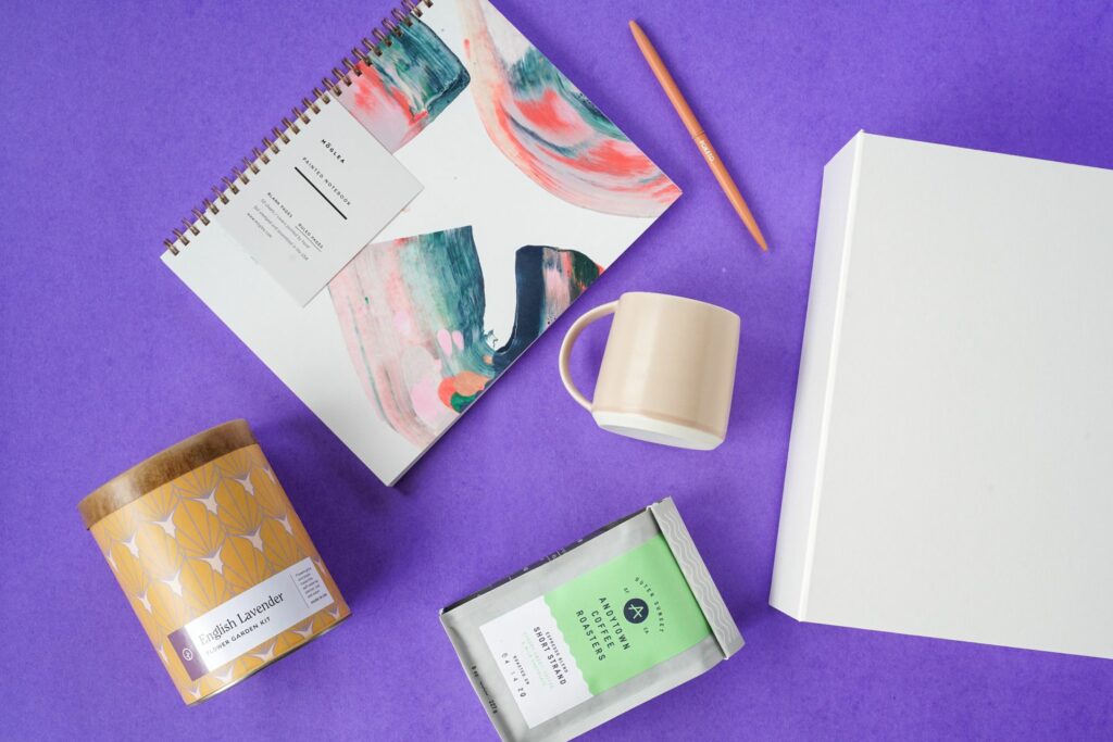 A notebook, coffee mug, box, and candle