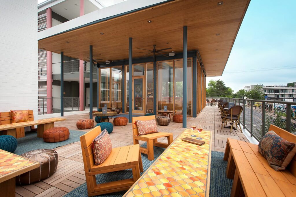 An expansive rooftop bar with many lounge areas