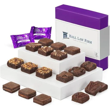 Small square brownies in front of a gift box