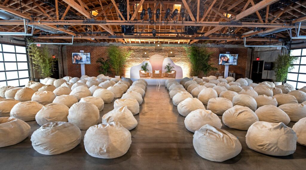 A large room with exposed wood beams with bean bags