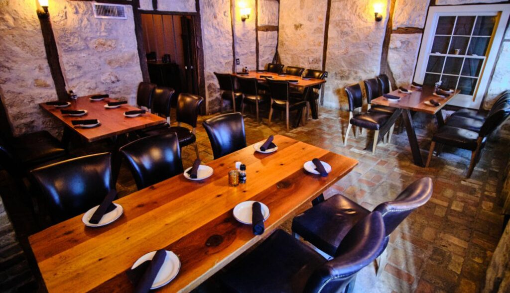 Inside a restaurant with wooden tables and brown leather chairs