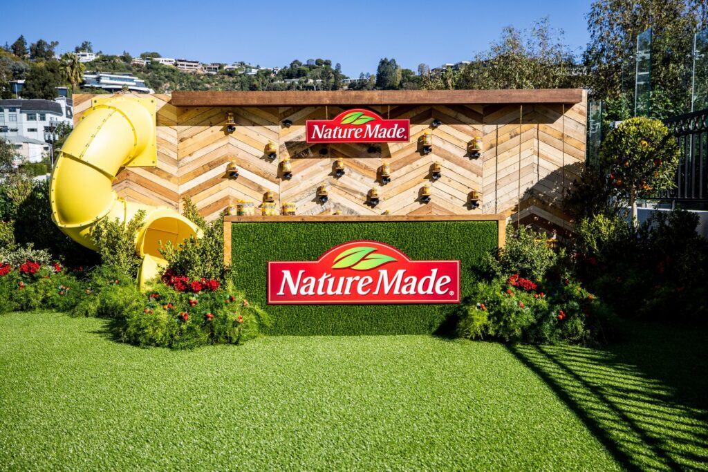 A wooden wall and slide structure with a Nature Made sign in front