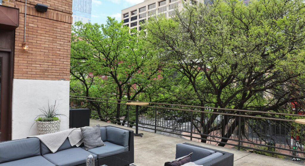 Rooftop space with lounge area looking out at trees