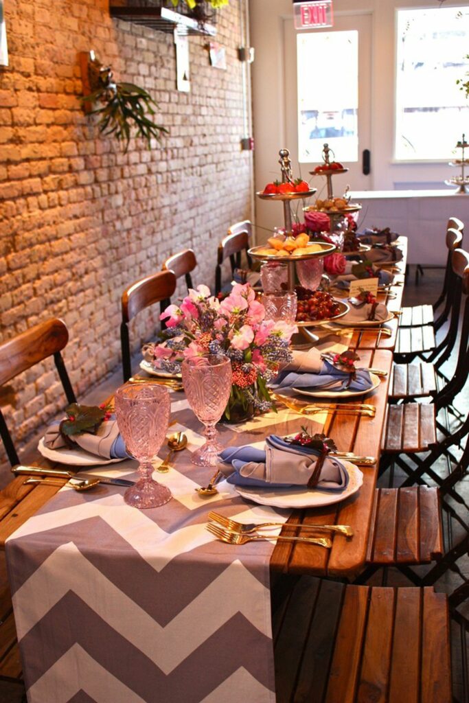 Long wooden dining table with chevron runner and florals