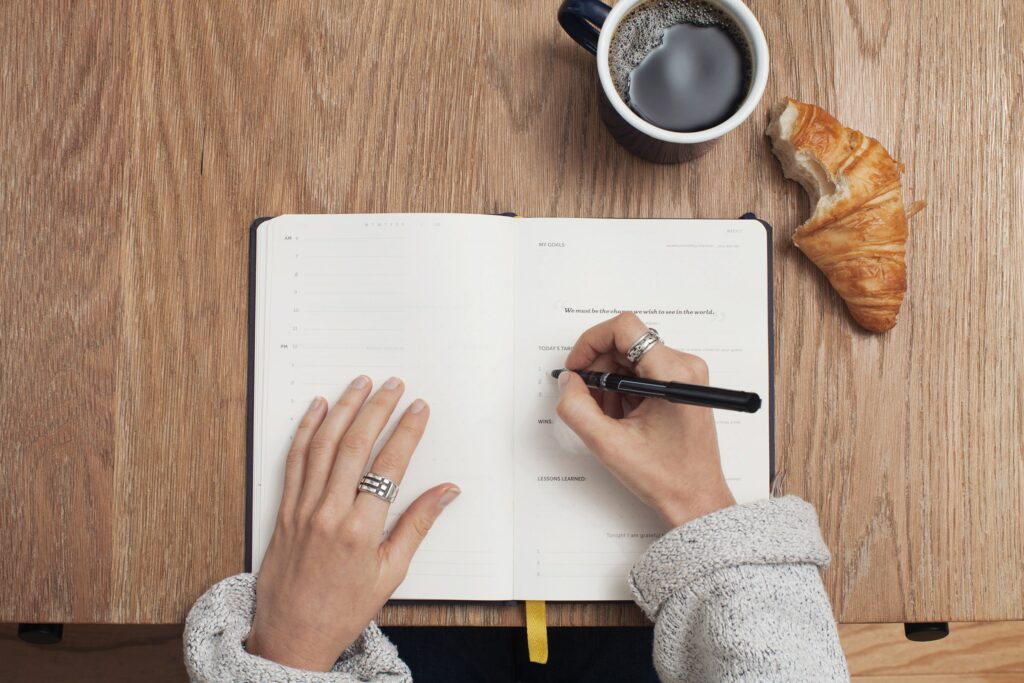 Woman's hand writing in a journal