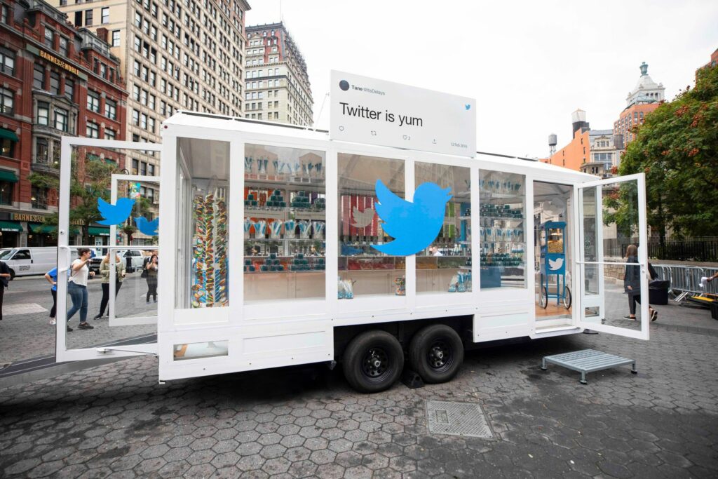 A large see through mobile vehicle with the twitter logo