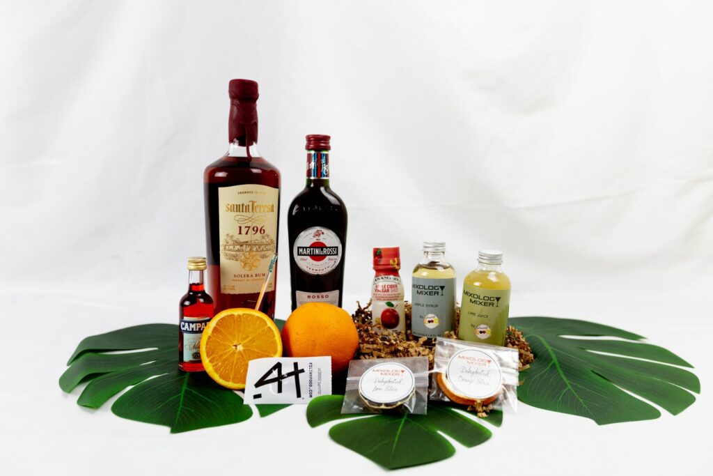 A collection of cocktail ingredients displayed on large leaves