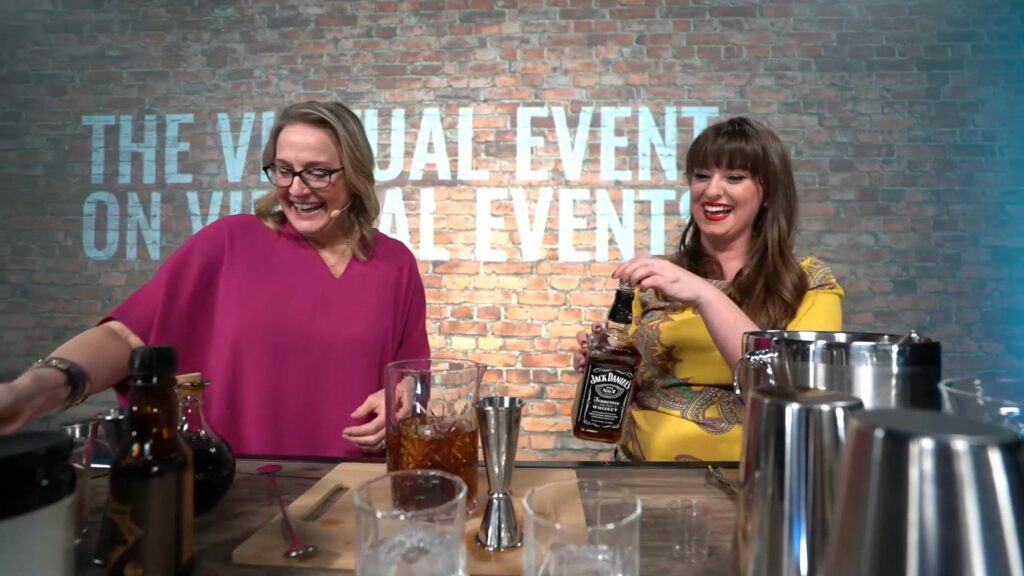 Two women making a cocktail at a bar