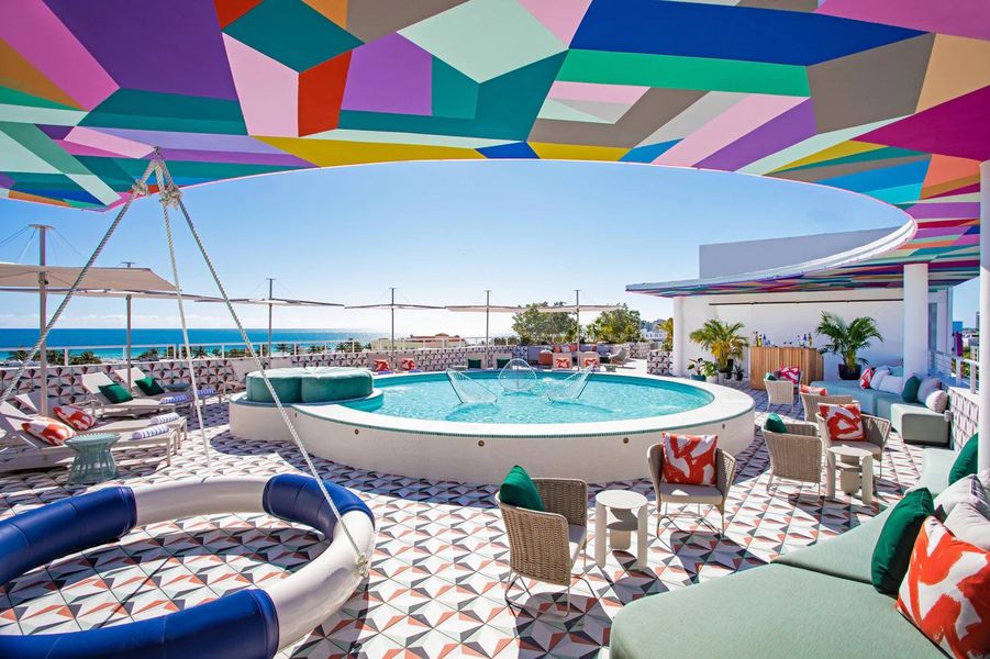 Rooftop bar in Miami with a circular pool and colorful lounge sets 