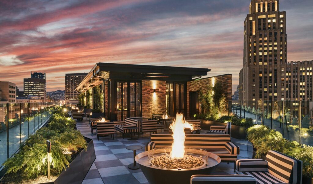Rooftop bar looking out at San Francisco skyline with fire place