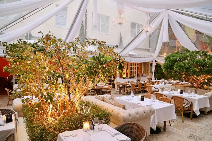 Outdoor patio space with draped covered awning 