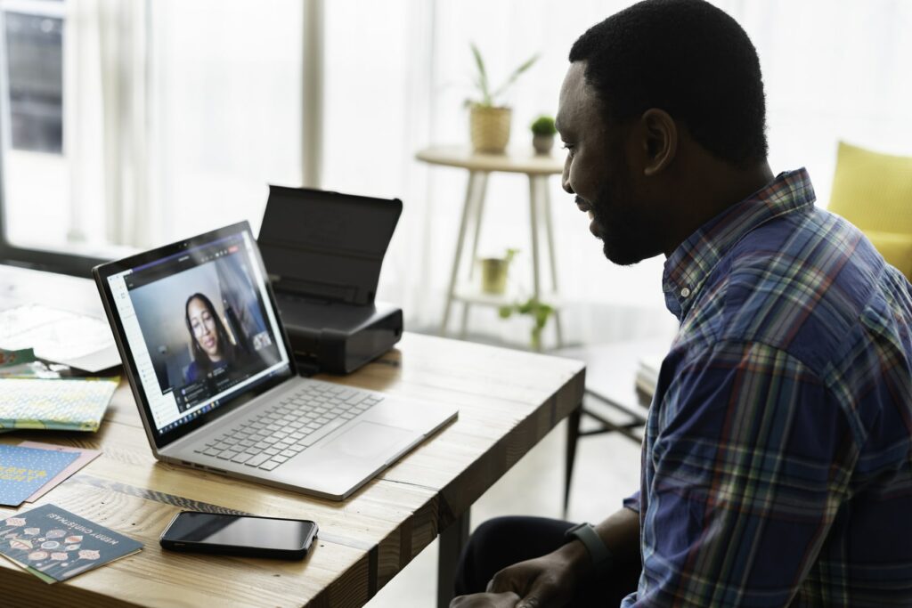 Man chatting with a woman on a computer video platform