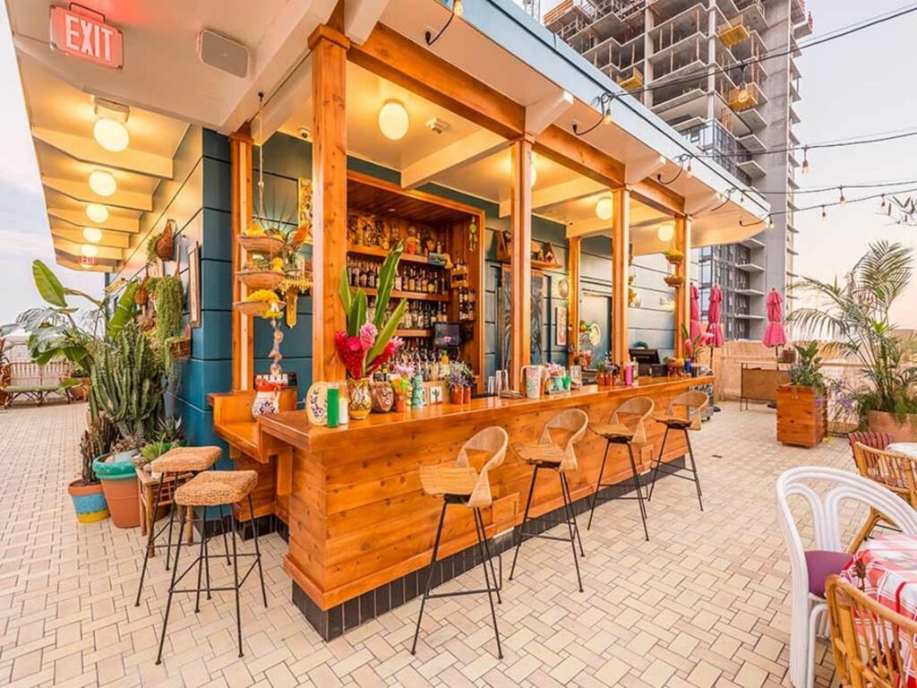 Tropical bar set up with wood trim and nice plants at the Broken Shaker in LA