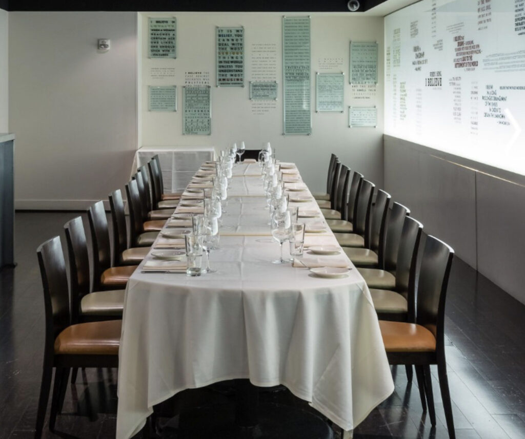 Long dining table with cream tablecloth 