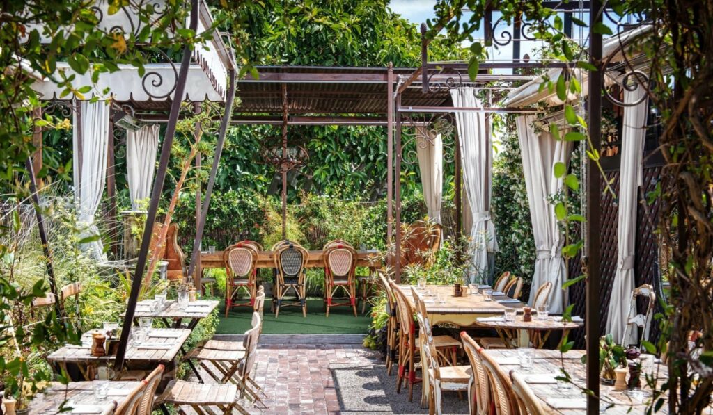 The lush rooftop at Peit Ermitage in Los Angeles with hanging drapes and lush greenery