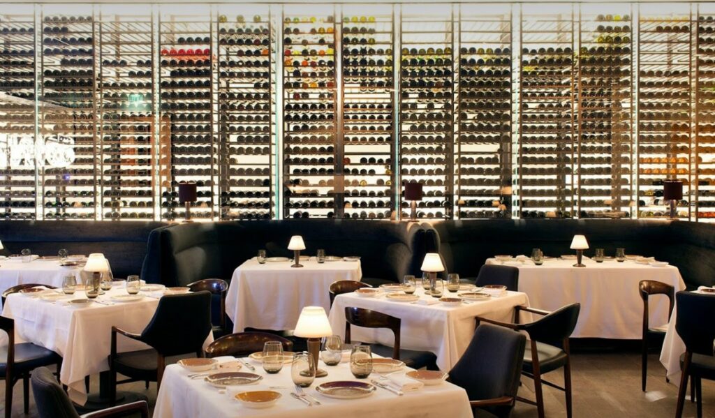 Spago in Los Angeles with large wine racks lining the dining space