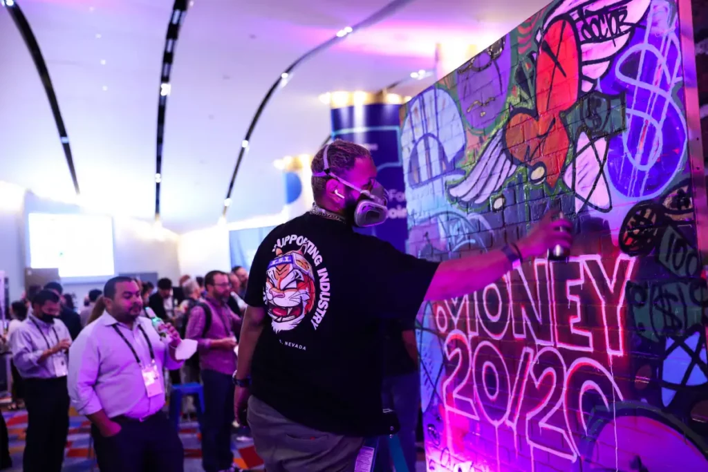 A graffiti artist painting at an a Money 20/20 event