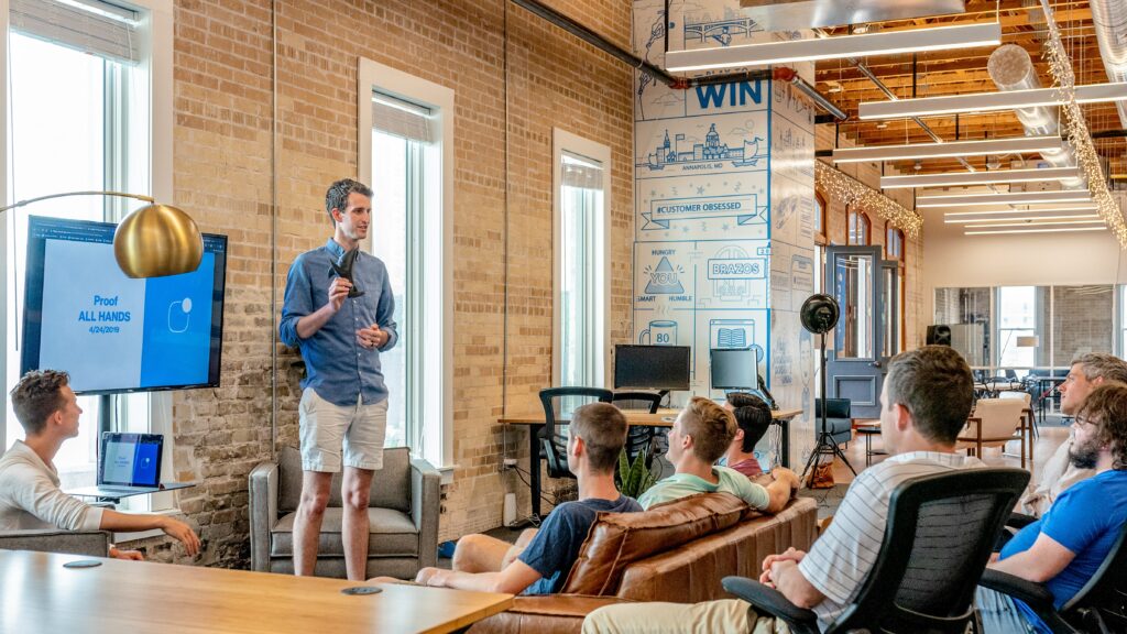 A guy giving a presentation to a group of people