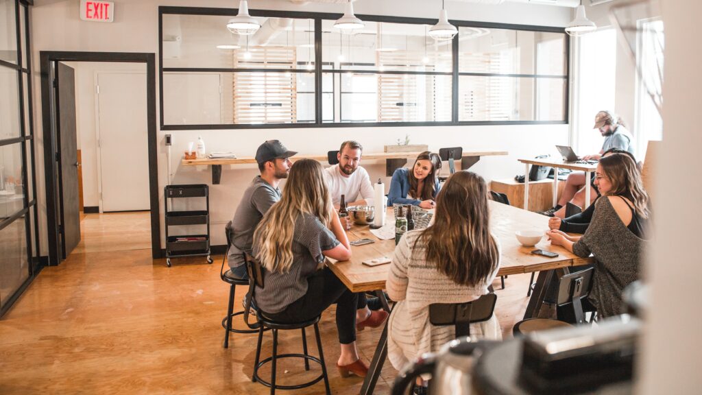 A group of people in an office drinking beers