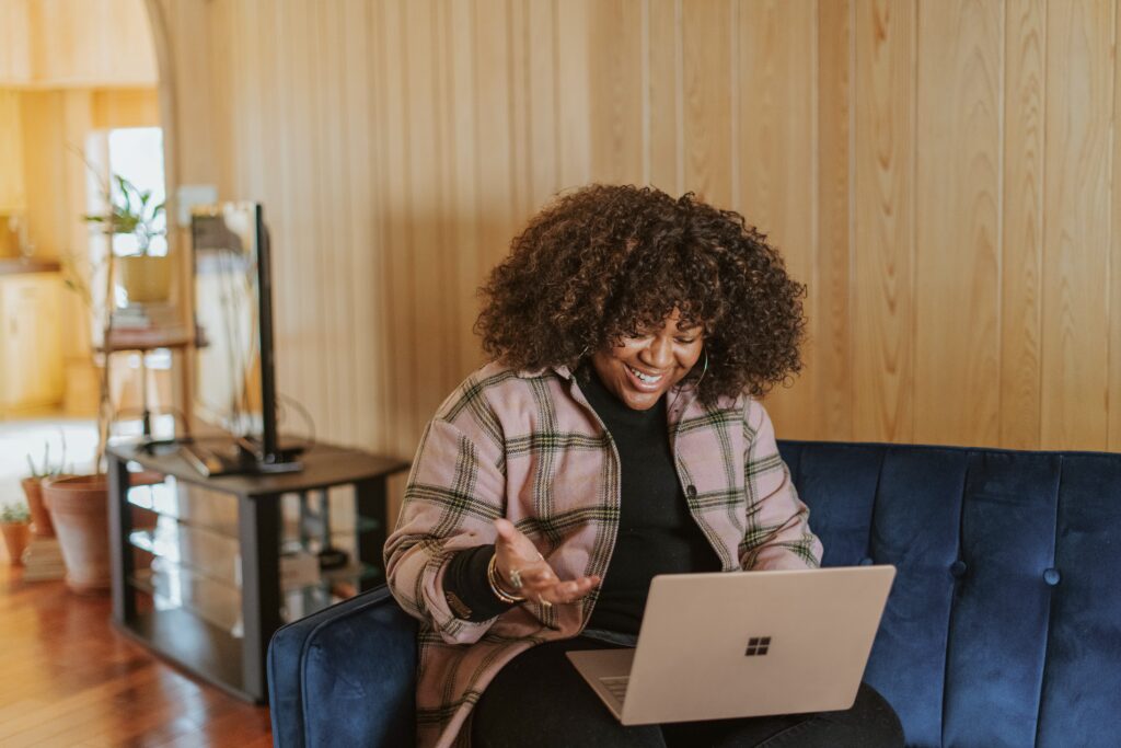 a girl on her laptop watching a virtual conference