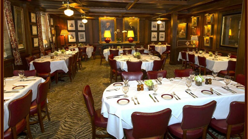 Bones private dining area with white table cloths and red leather chairs