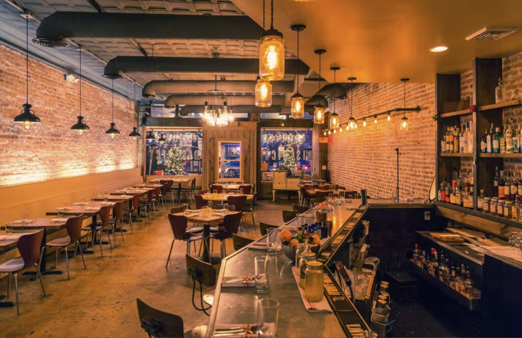 District Kitchen in Washington D.C. with exposed brick walls and Edison bulb lighting