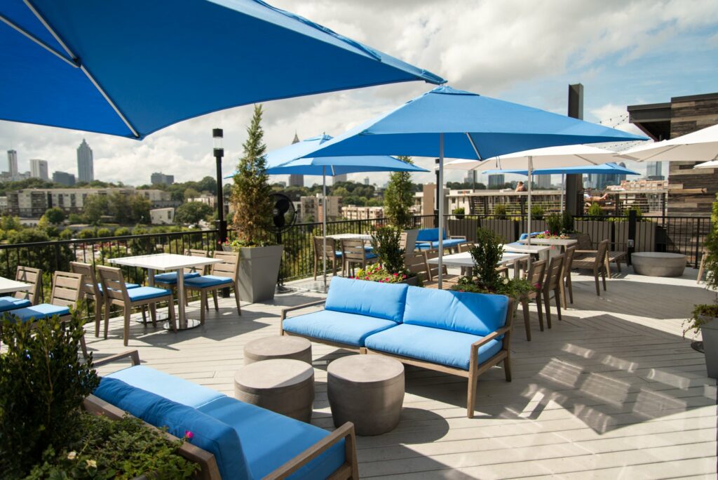 Estrella rooftop in Atlanta with blue cushions seats and umbrellas 