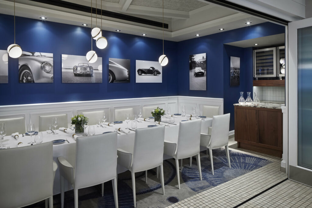 Private dining room at Fiola Mare with white booths, chairs, and tables.