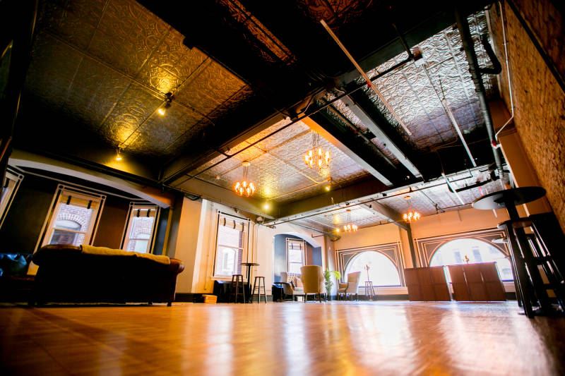 Large open event space at the National Union Building with a patterned ceiling and warm lighting