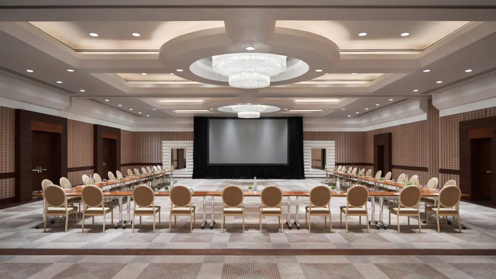 Large event space with tables, chairs, and a large tv projection screen at Park Hyatt in Washington D.C.