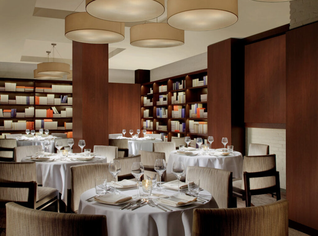 Rasika West End Library Room with books lining the shelves