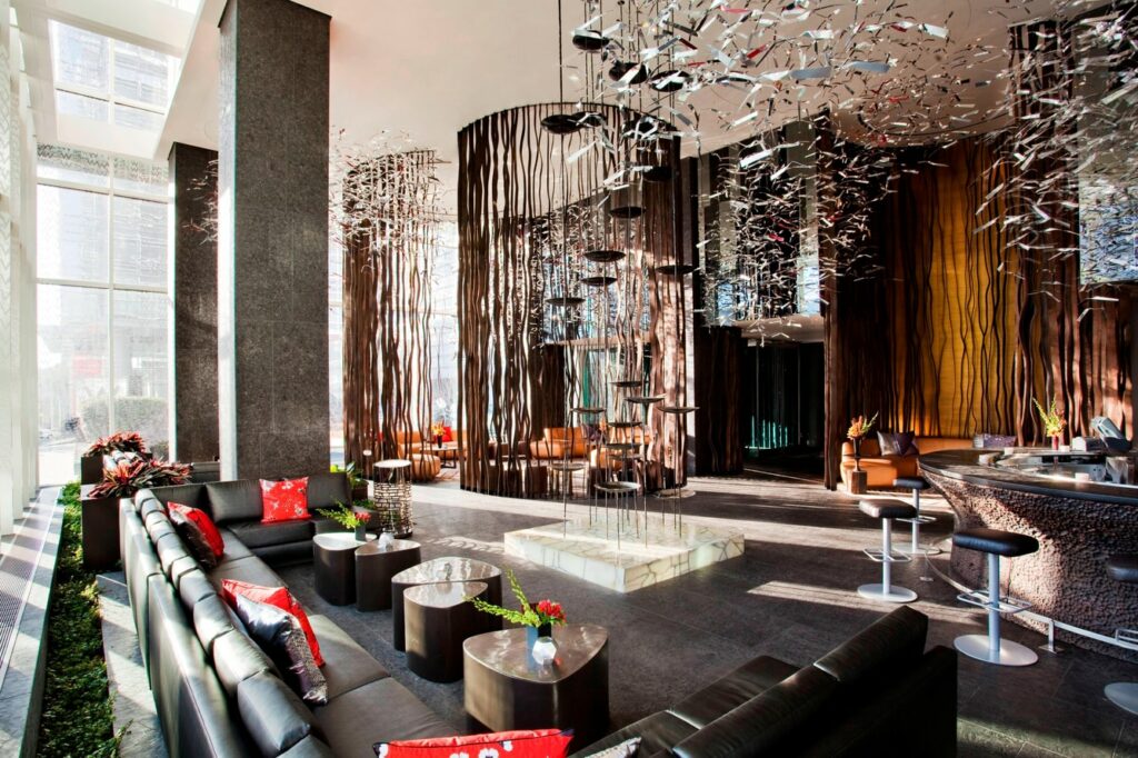 The swanky hotel lobby of the W Atlanta with black couches, and hanging installations
