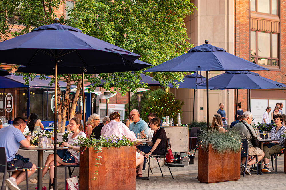 Alcove in Boston outdoor seating with large blue umbrellas 