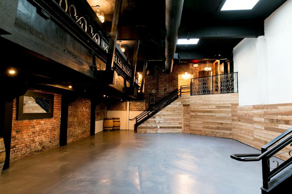 First and Bell in Seattle with concrete flooring, exposed brick, and wooden beams