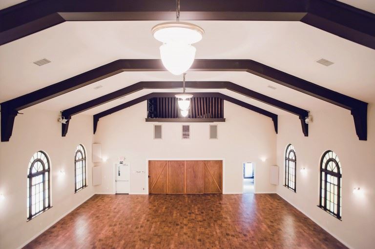 Fremont Abbey Arts Center in Seattle with high ceilings arched windows, and wooden flooring