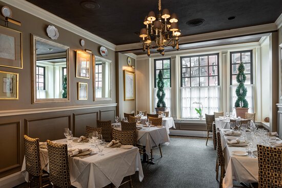 Mamma Maria in Boston with white table cloth dining tables and traditional décor.