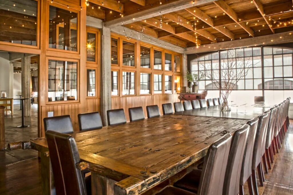 Large wooden dining table and chairs at The Box SF venue